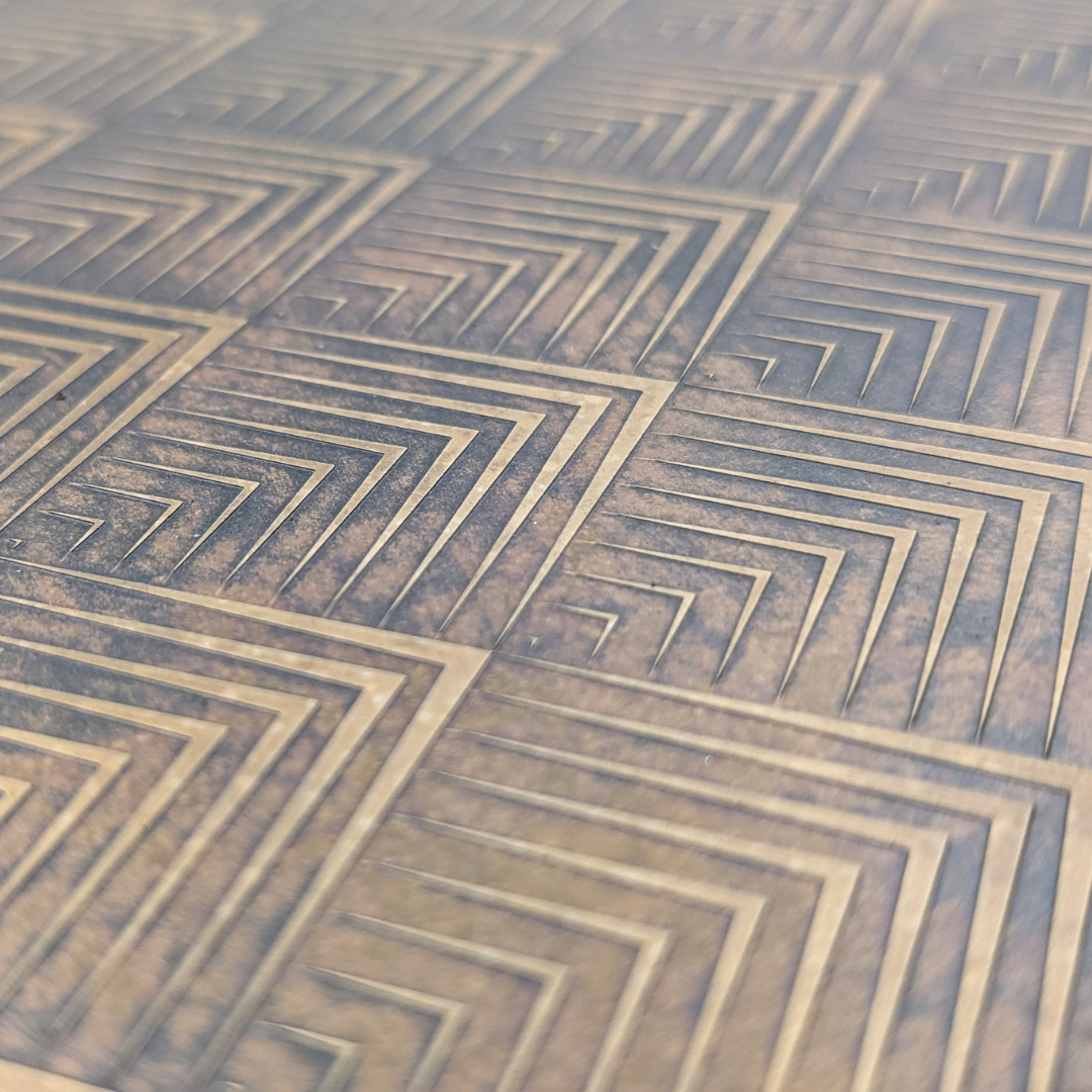 Aged geometric brass with deep recessed linework